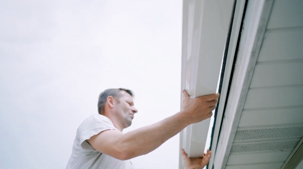 Valley Roofing & Exteriors employee adding seamless gutters